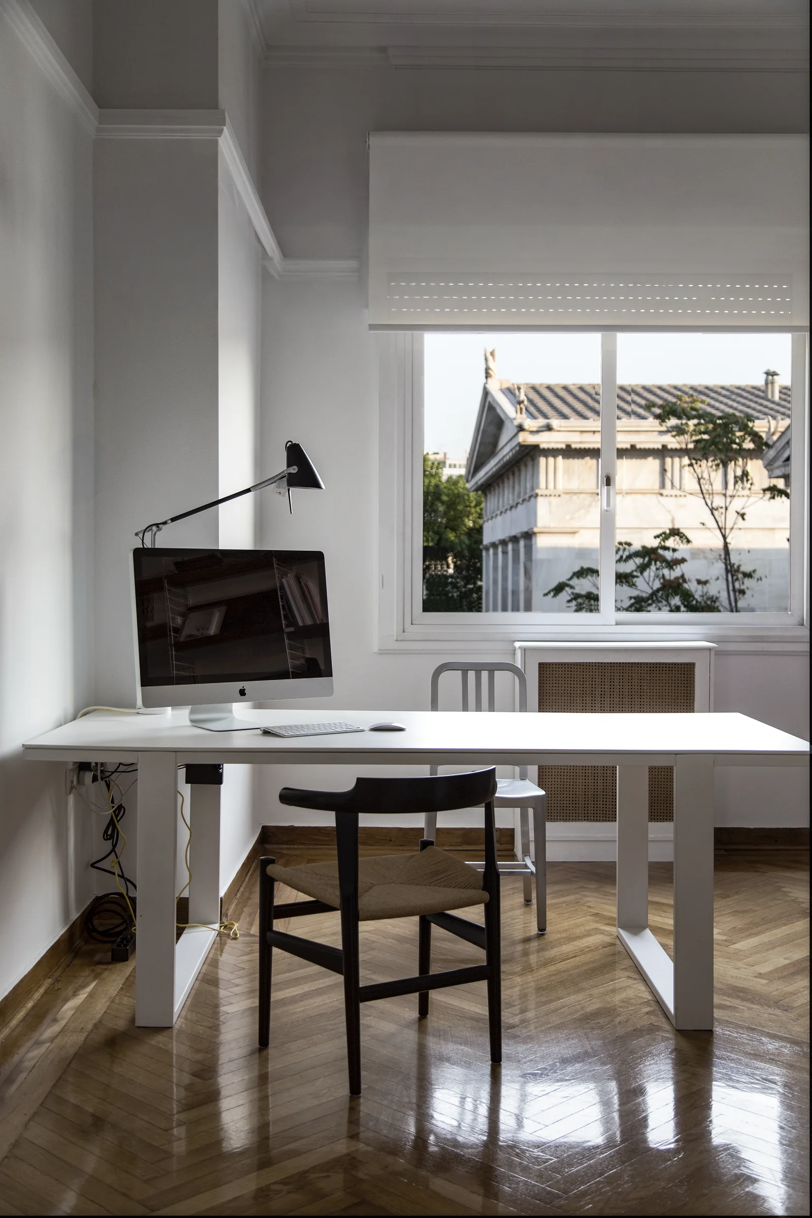 Bombyx — Desk and chairs beside the window overlooking Athens