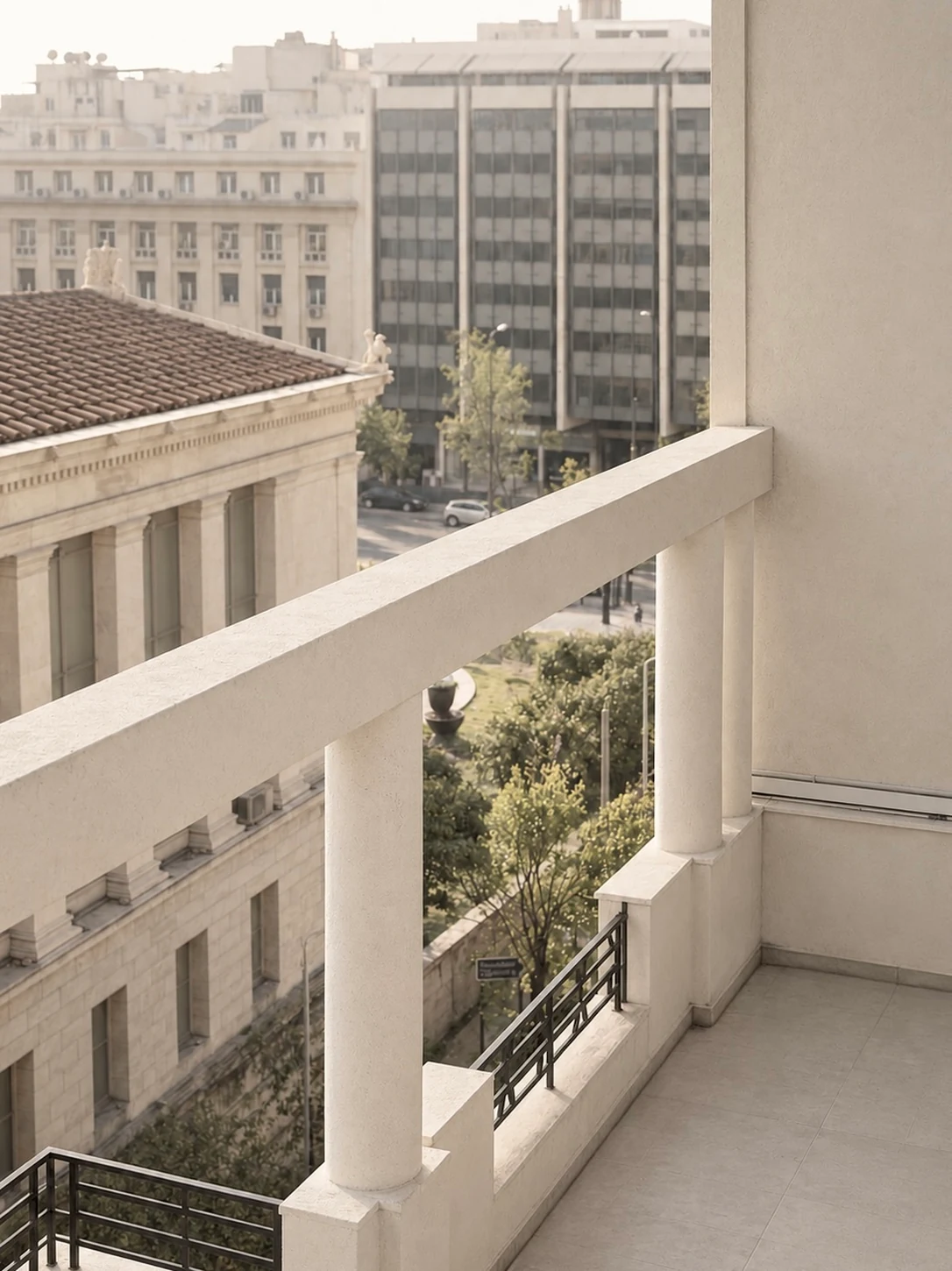 Bombyx — Balcony overlooking central Athens, framed by columns and warm afternoon light